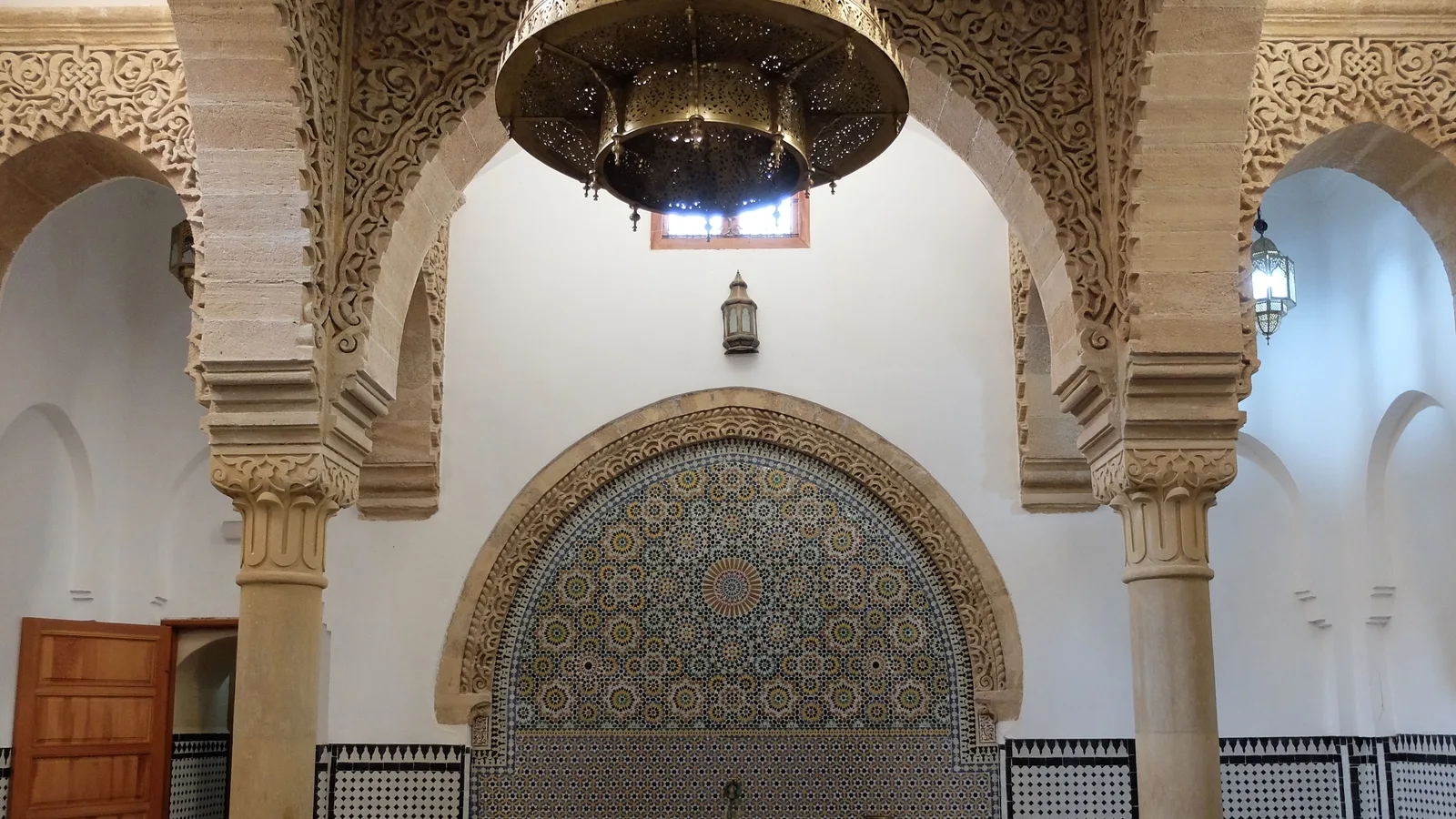 The zellij-tiled reception hall of the restored 14th-century Hammam Saffarin in Fes