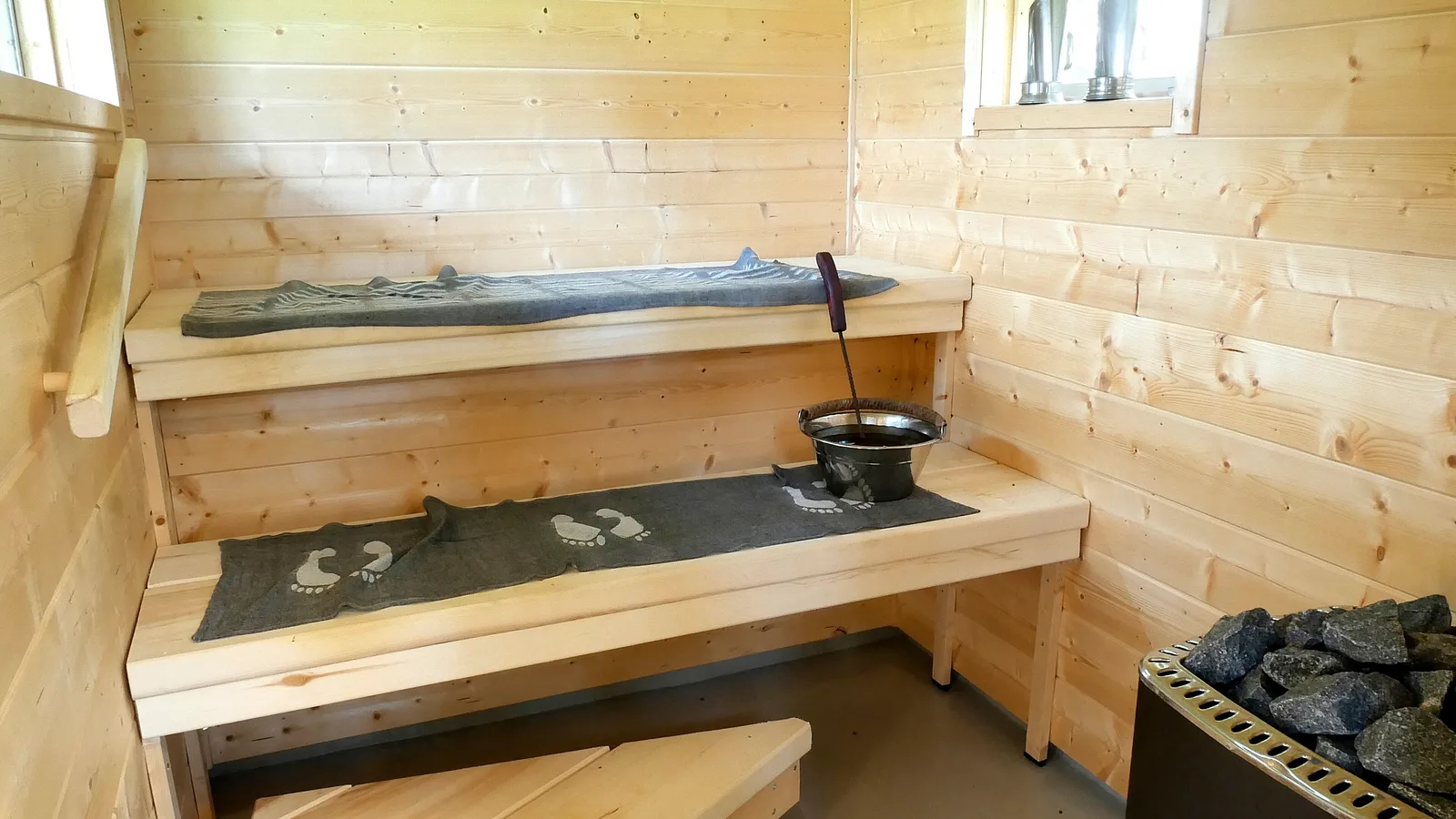 Wooden two-level sauna bench structure with clean lines and proper spacing between tiers